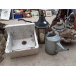 A WHITE BELFAST SINK, A GALVANISED WATERING CAN AND A CANDLE LANTERN