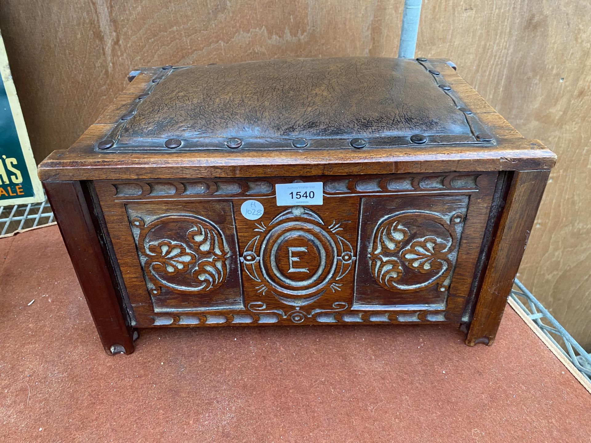 A WOODEN CARVED ARTS & CRAFTS FOOT STOOL