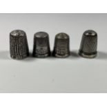 A GROUP OF THREE HALLMARKED SILVER THIMBLES AND FURTHER PLATED EXAMPLE