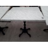 A PUB TABLE WITH WOODEN TOP AND CAST IRON TABLE BASE (79CM x 79CM)