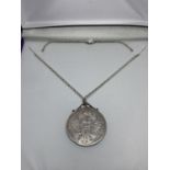 A SILVER COIN NECKLACE IN A PRESENTATION BOX