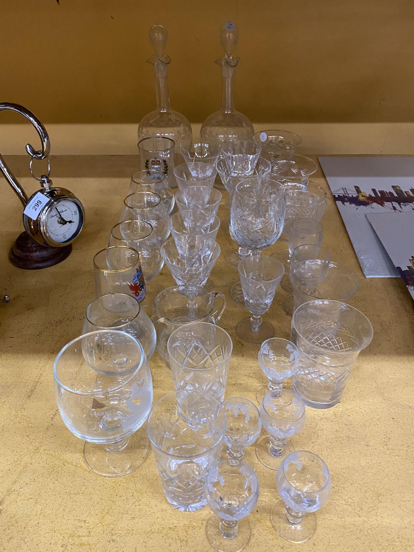 A LARGE QUANTITY OF GLASSWARE TO INCLUDE CUT GLASS - ETCHED DECANTERS, DESSERT BOWLS, LICQUER