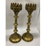 A PAIR OF VINTAGE BRASS GOTHIC STYLE CANDLE HOLDERS, HEIGHT 49CM