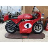 A HONDA RC166 MODEL FAIRGROUND RIDE MOUNTED ON A WOODEN PLINTH