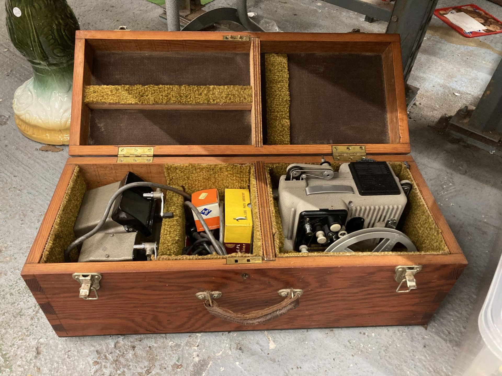 A CINE CAMERA IN A WOODEN CARRY BOX