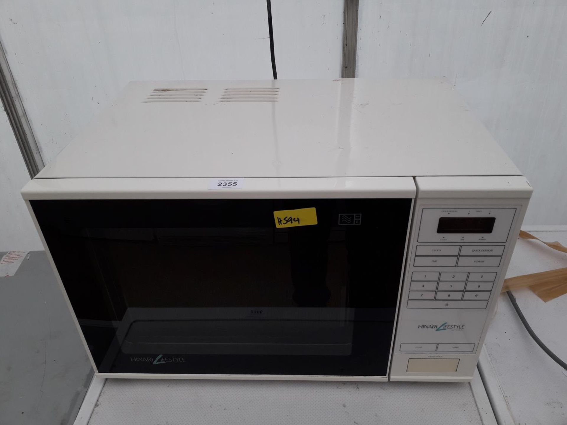 A WHITE AND BLACK HINARI LIFESTYKE MICROWAVE OVEN