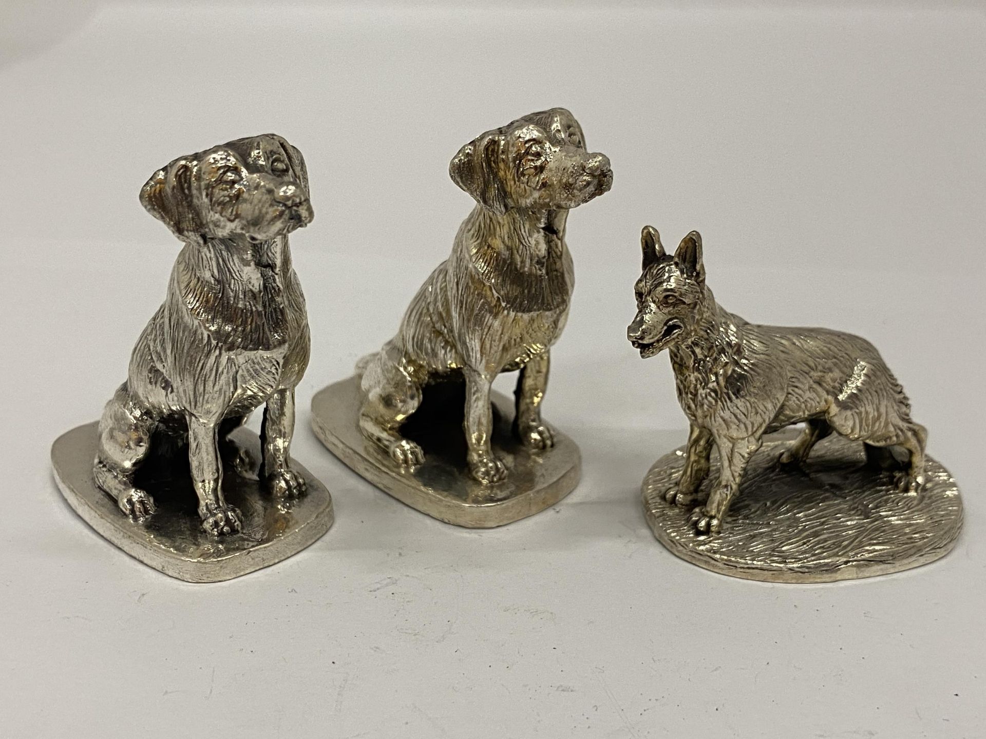 A GROUP OF THREE HALLMARKED SILVER FILLED CAMELOT SILVERWARE LTD DOG FIGURES