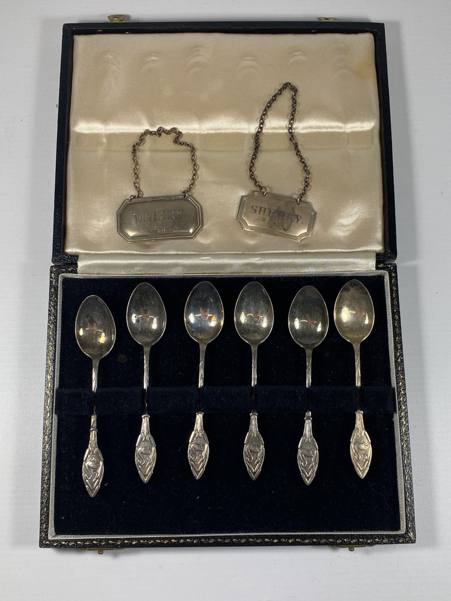 A CASED SET OF SIX HALLMARKED SILVER TEASPOONS WITH SWAN DESIGN HANDLE AND TWO SILVER DECANTER