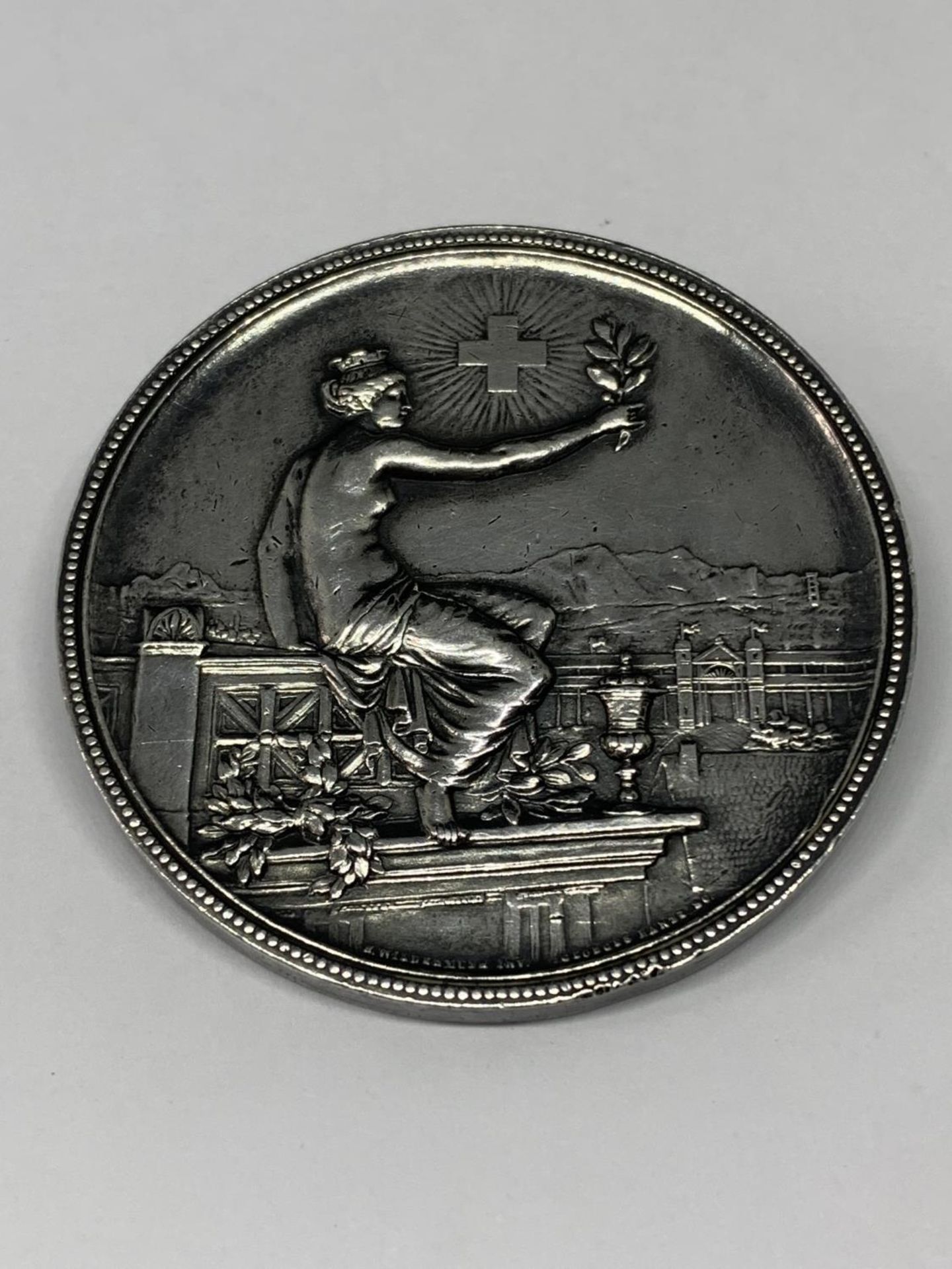A SILVER SWISS 1895 SHOOTING MEDAL IN THE FORM OF A BROOCH