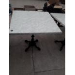 A PUB TABLE WITH WOODEN TOP AND CAST IRON TABLE BASE (79CM x 79CM)