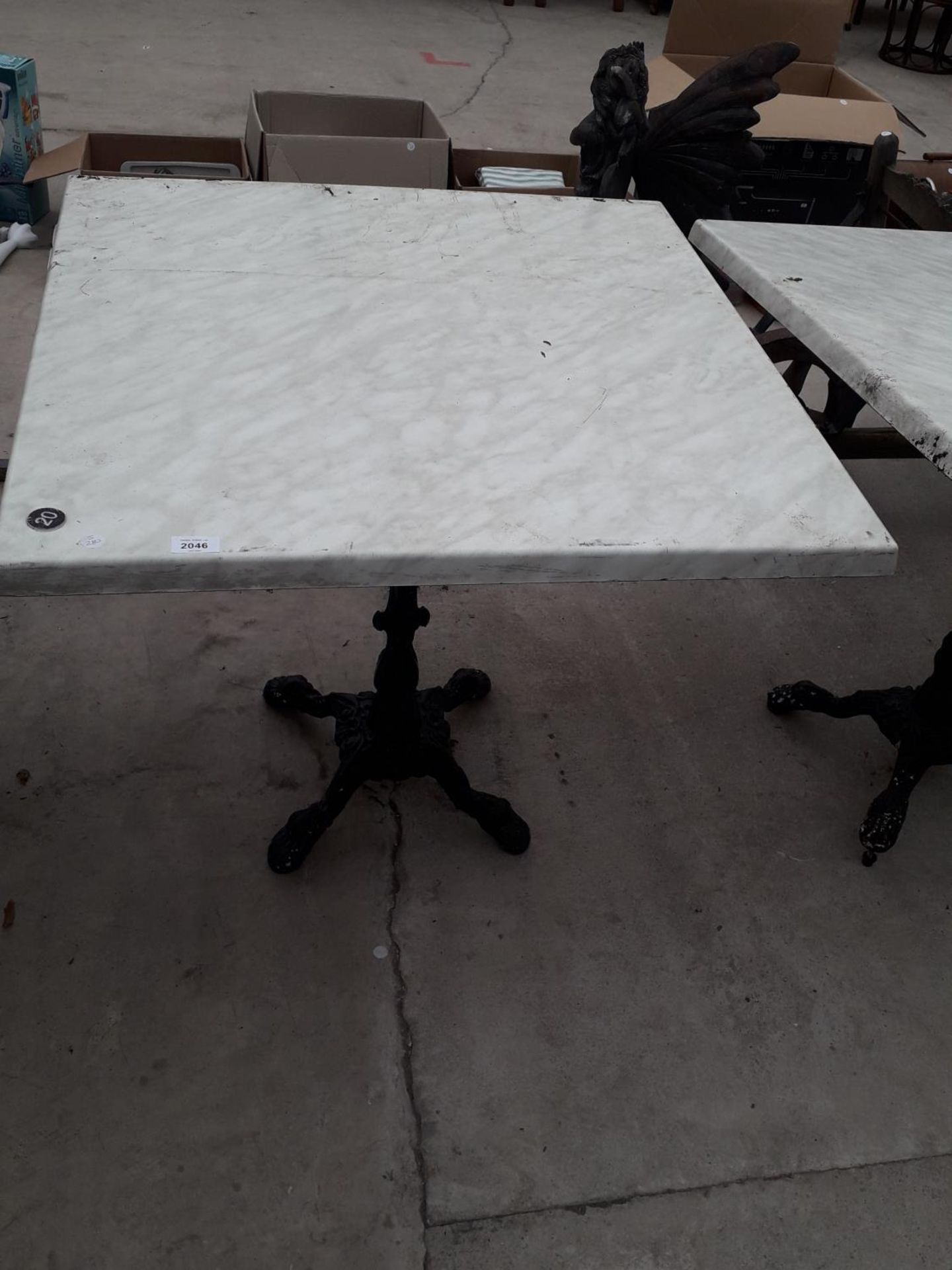 A PUB TABLE WITH WOODEN TOP AND CAST IRON TABLE BASE (79CM x 79CM)