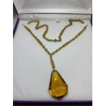 A YELLOW COLOURED NECKLACE IN A PRESENTATION BOX