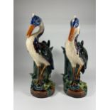 A PAIR OF VICTORIAN MAJOLICA STYLE CONTINENTAL STORK FIGURES HEIGHT 38CM