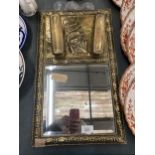 A VINTAGE BRASS FRAMED MIRROR WITH GALLEON TOP AND TWO BRUSHES