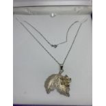 A SILVER LEAF DESIGN PENDANT IN A PRESENTATION BOX