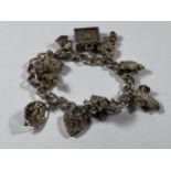 A SILVER HEART PADLOCK CHARM BRACELET WITH NINE CHARMS