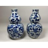 A PAIR OF QING 19TH CENTURY CHINESE BLUE AND WHITE KANGXI STYLE DOUBLE GOURD VASES, FOUR CHARACTER