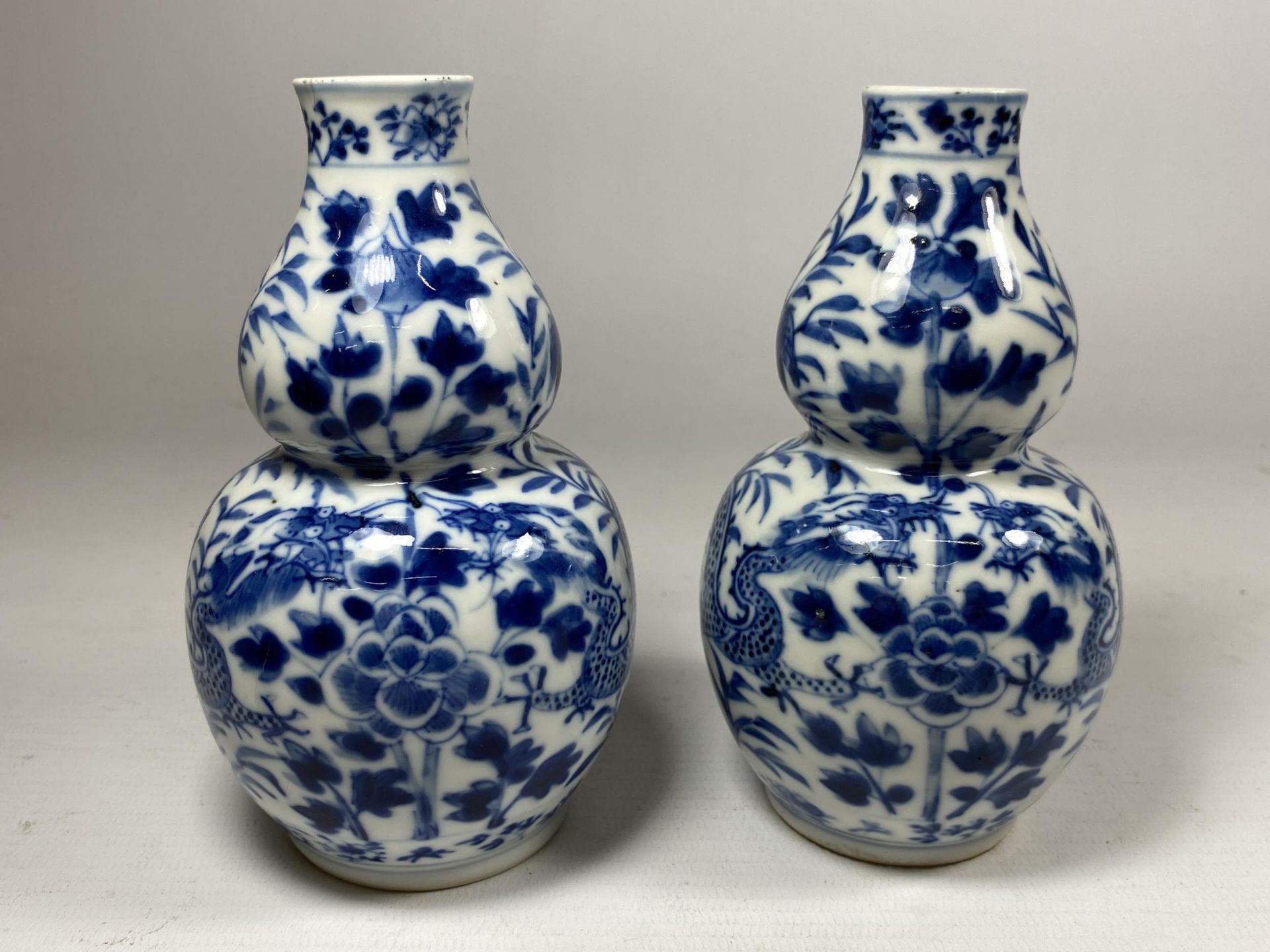 A PAIR OF QING 19TH CENTURY CHINESE BLUE AND WHITE KANGXI STYLE DOUBLE GOURD VASES, FOUR CHARACTER