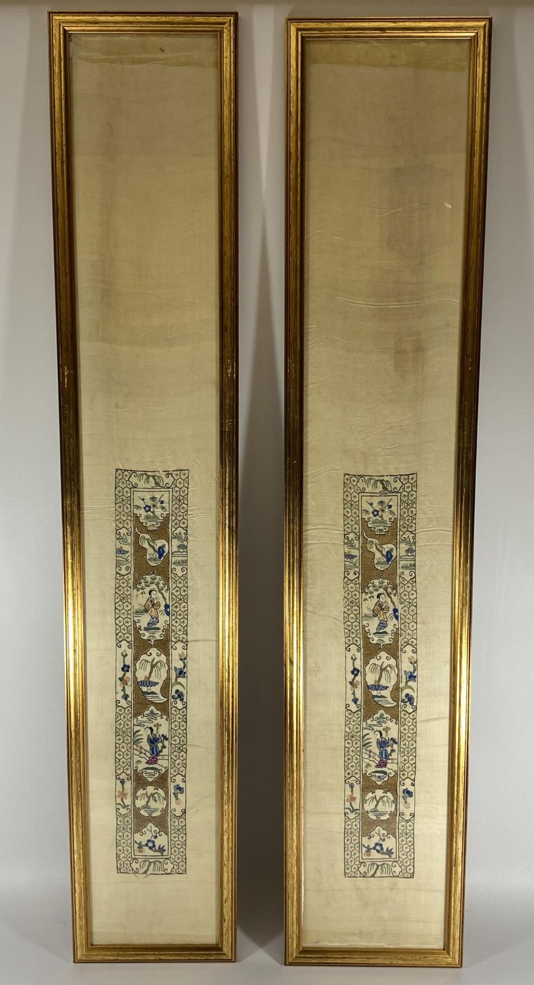 A LARGE PAIR OF GILT FRAMED CHINESE SILK PICTURES, 107 X 19CM