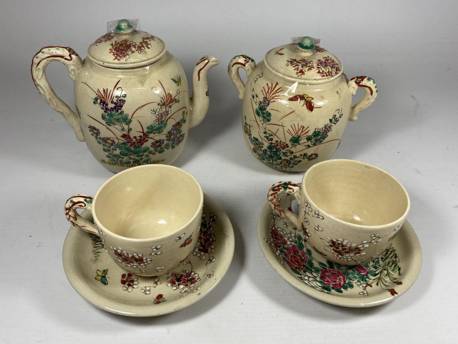 A JAPANESE TEA FOR TWO POTTERY SET COMPRISING TEAPOT, LIDDED SUGAR BOWL & TWO CUPS AND SAUCERS,