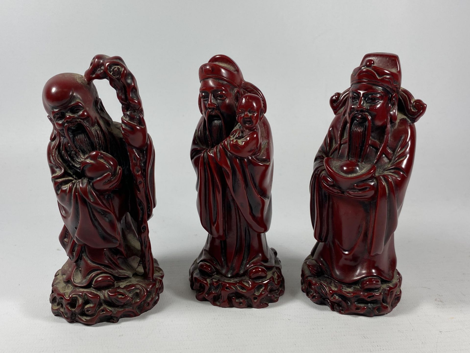 A GROUP OF THREE CHINESE RESIN MODELS OF IMMORTALS, HEIGHT 14CM