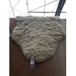 A SMALL SHEEP SKIN STYLE RUG