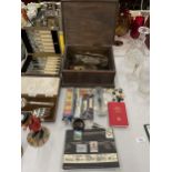 A WOODEN BOX CONTAINING VARIOUS ITEMS TO INCLUDE STAMPS, PENS, HOOKS, BEER MATS ETC