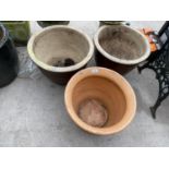 A PAIR OF LARGE CIRCULAR BROWN GLAZED PLANT POTS AND A FURTHER GLAZED TERACOTTA PLANT POT