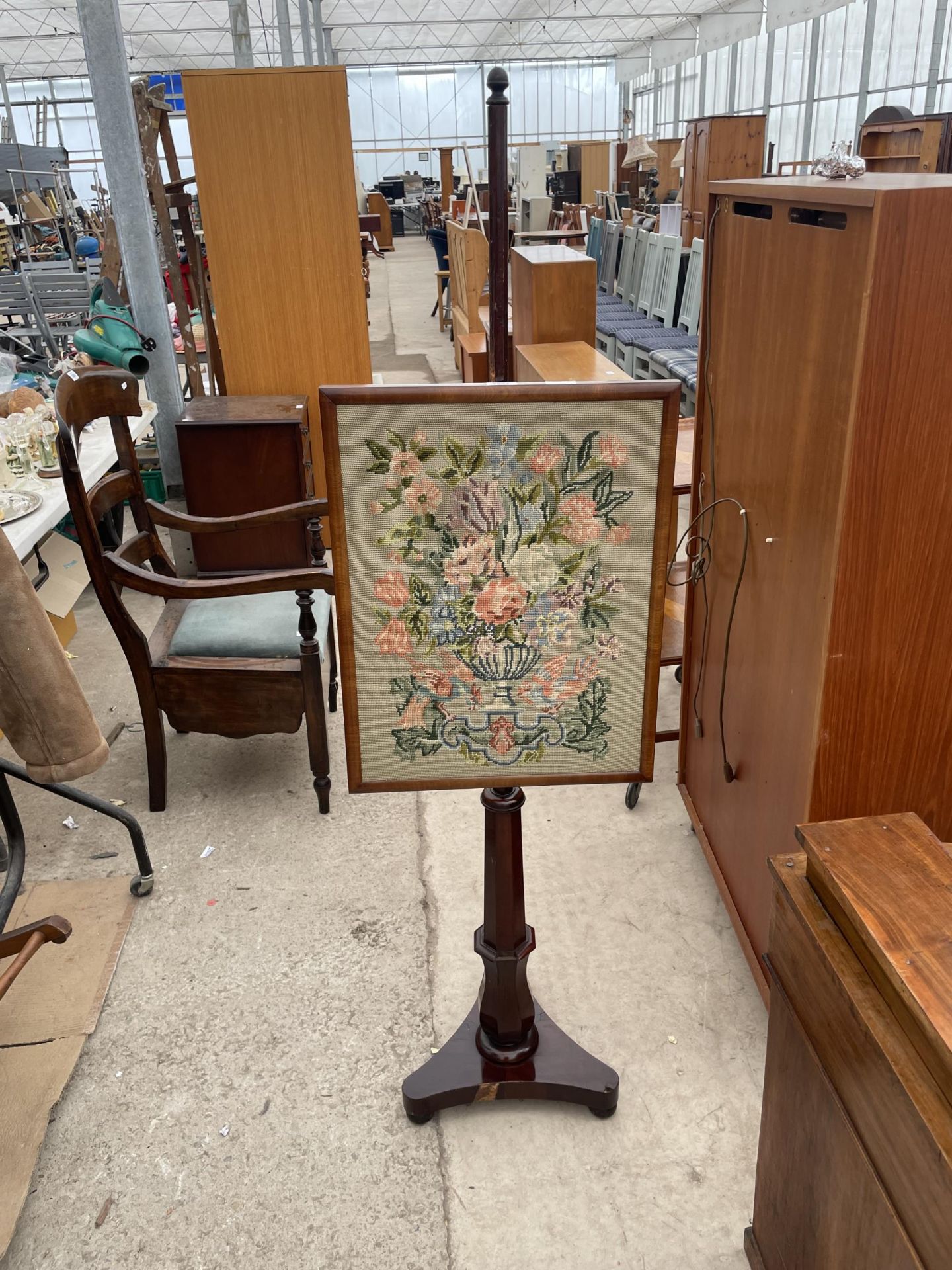 A VICTORIAN MAHOGANY POLE SCREEN WITH WOOLWORK PANEL