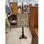 A VICTORIAN MAHOGANY POLE SCREEN WITH WOOLWORK PANEL