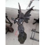 A WOODEN CARVED FAIRY FIGURE