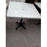 A PUB TABLE WITH WOODEN TOP AND CAST IRON TABLE BASE (79CM x 79CM)