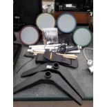 A PLAYSTATION DRUM KIT AND TWO GAMES TO INCLUDE GUITAR HERO WORLD TOUR