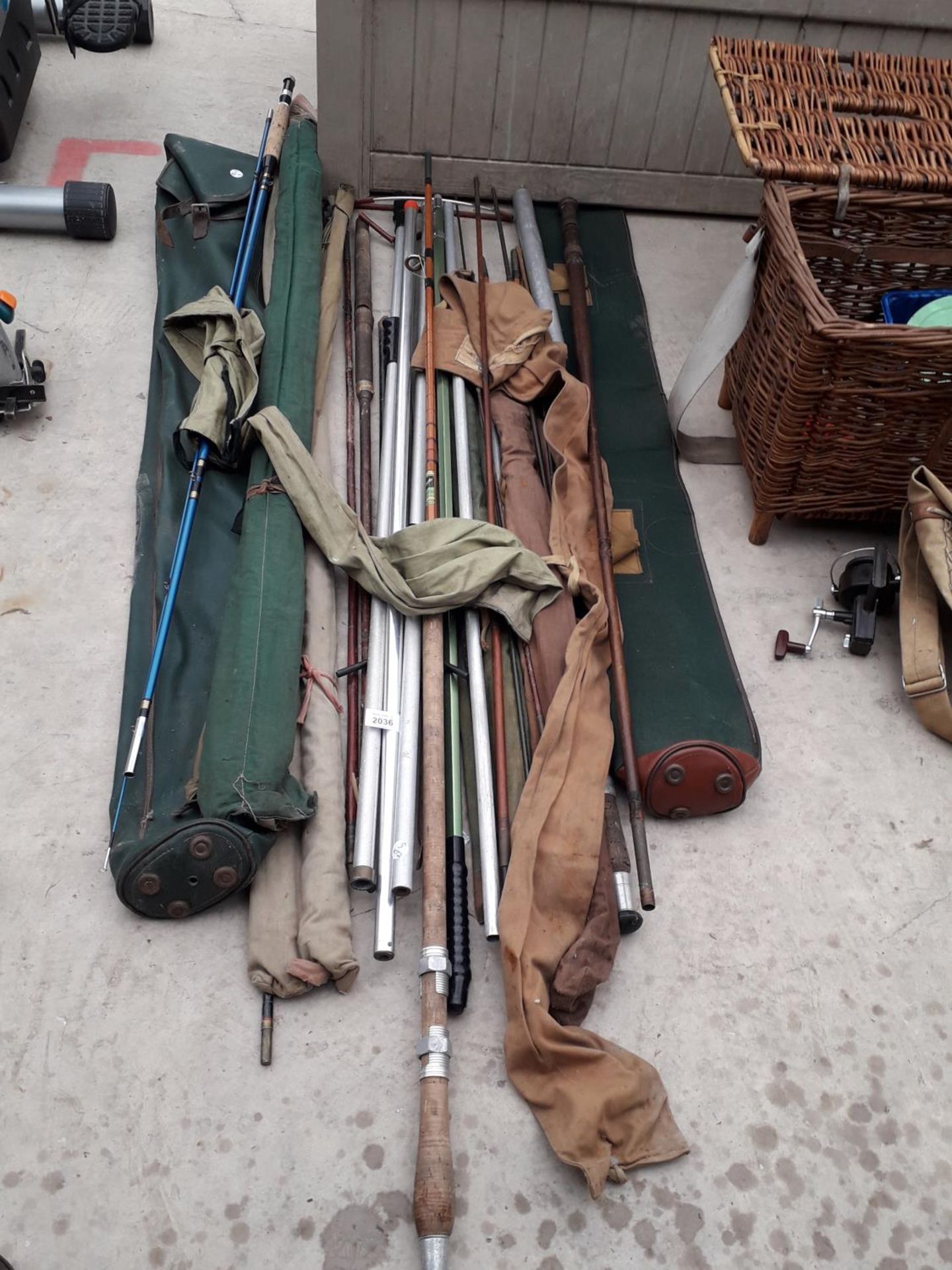 AN ASSORTMENT OF FISHING RODS AND ROD STANDS ETC