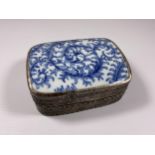 AN ORIENTAL BLUE AND WHITE LIDDED WHITE METAL BOX