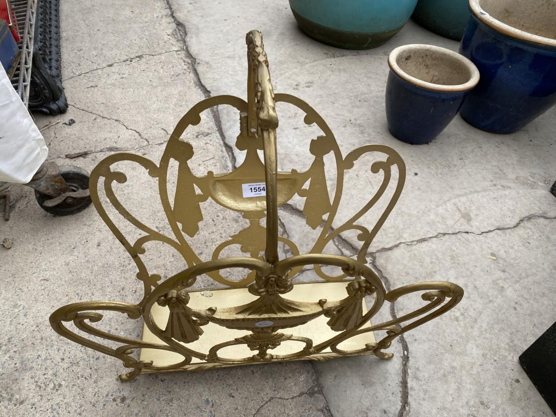 AN ORNATE METAL MAGAZINE RACK