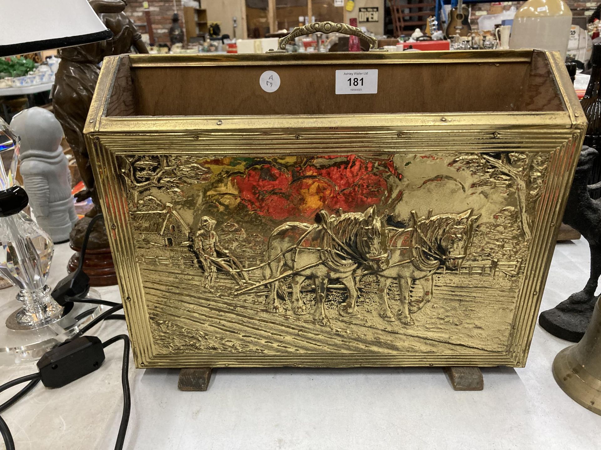 A BRASS MAGAZINE RACK WITH SHIRE HORSE DESIGN