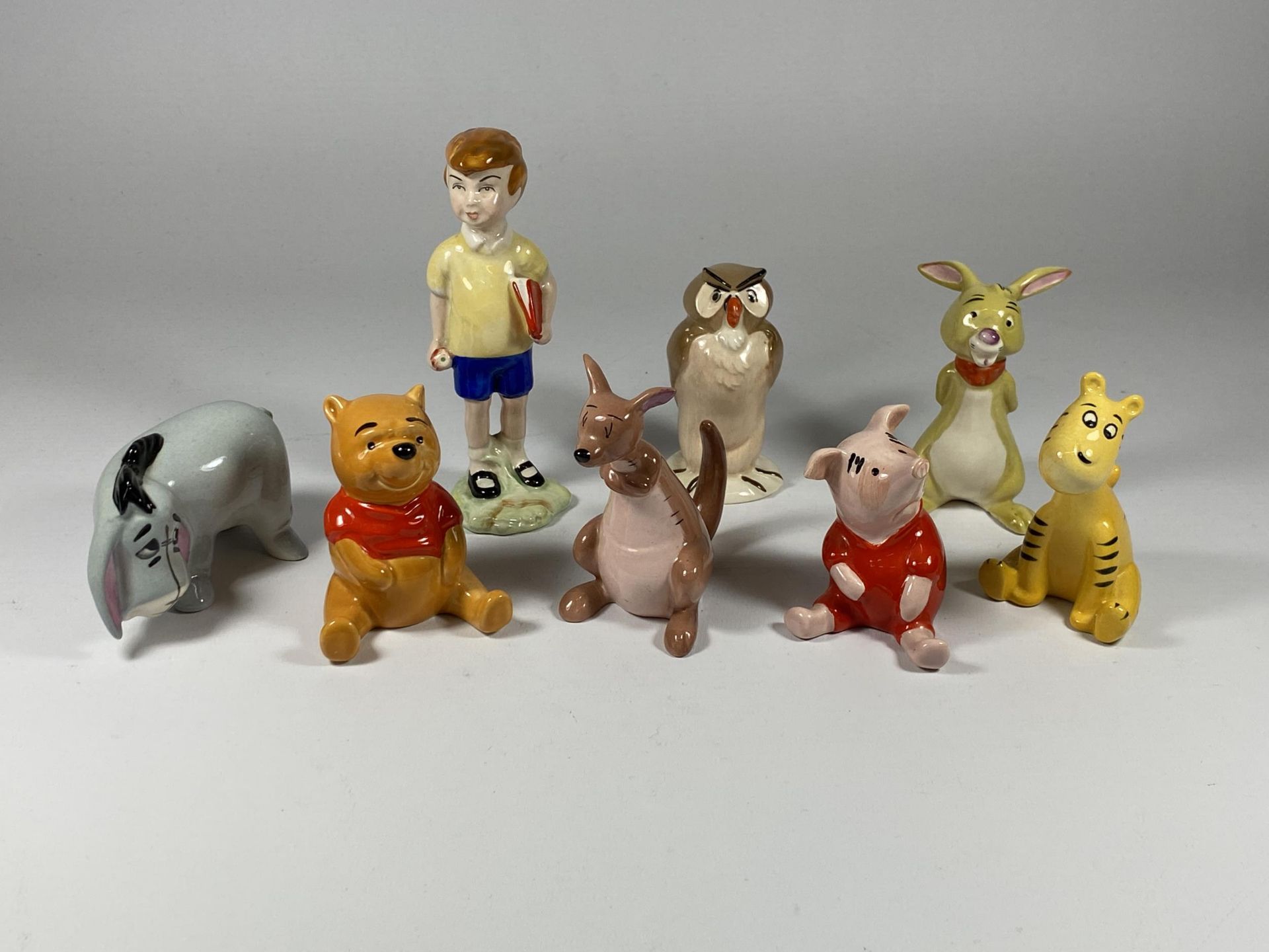 A SET OF EIGHT BESWICK WALT DISNEY WINNIE THE POOH FIGURES