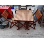 A SMALL TEAK BISTRO SET COMPRISING OF A SQUARE FOLDING TABLE AND TWO FOLDING CHAIRS