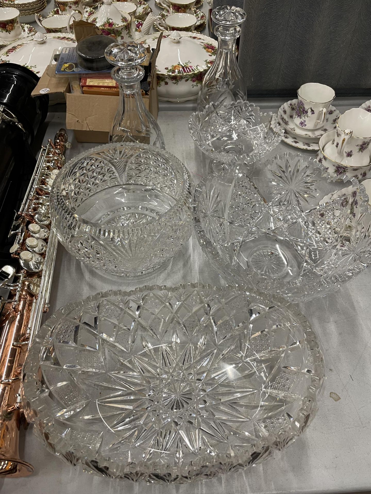 SEVEN CUT GLASS ITEMS TO IONCLUDE THREE LARGE BOWLS, A BON BON DISH AND TWO DECANTERS