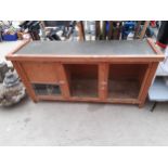 A LARGE WOODEN PET HUTCH WITH MESH FRONT
