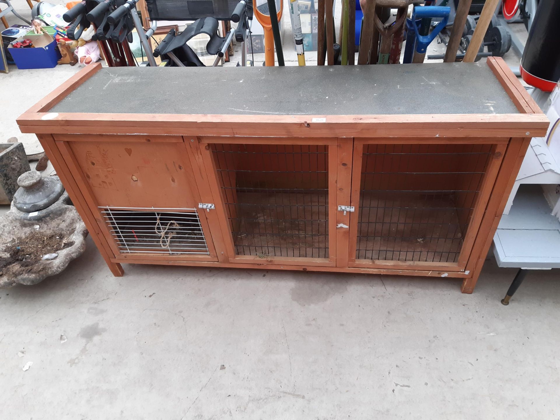 A LARGE WOODEN PET HUTCH WITH MESH FRONT