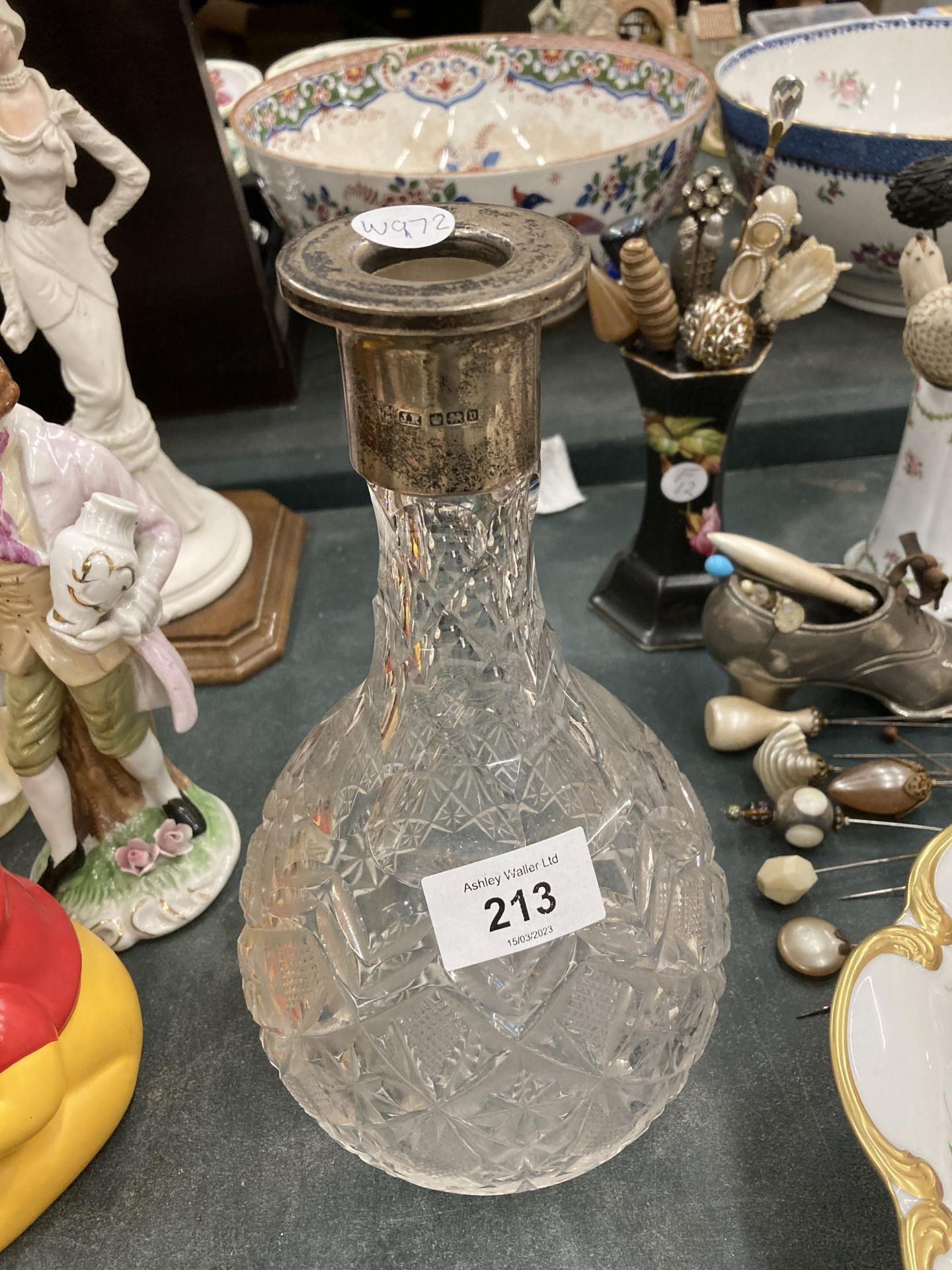 A CUT GLASS DECANTER WITH A HALLMARKED SHEFFIELD SILVER COLLAR