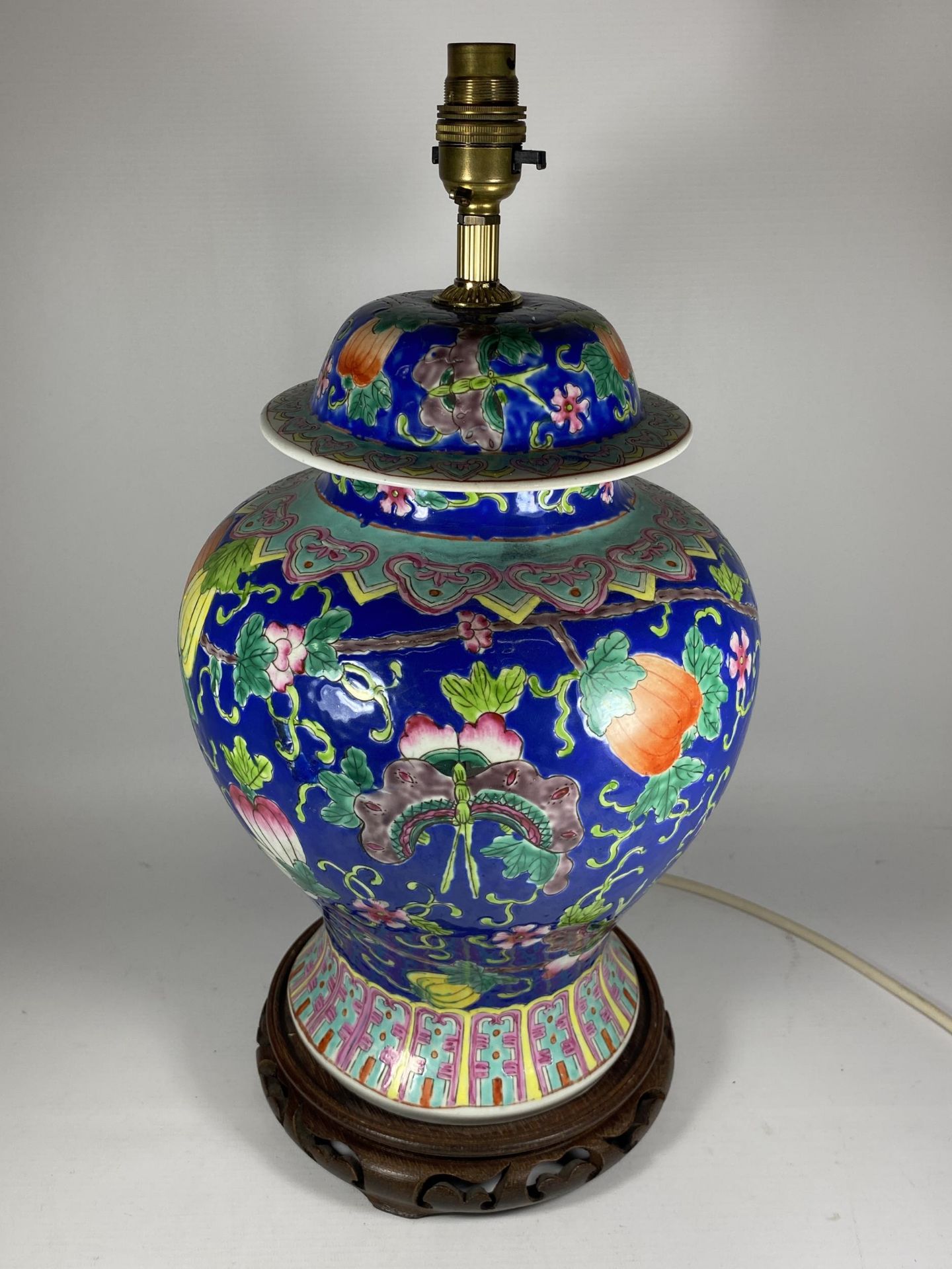 A LARGE CHINESE ENAMEL DESIGN PEACH BLOSSOM TABLE LAMP ON CARVED WOODEN BASE, HEIGHT INCLUDING