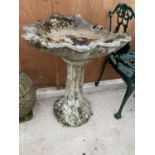 A RECONSTITUTED STONE BIRD BATH WITH PEDESTAL BASE AND SHELL DESIGN TOP (H:71CM)