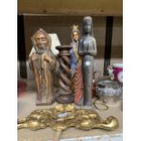 A MIXED LOT TO INCLUDE RELIGIOUS CARVED FIGURES, A LARGE BARLEY TWIST WOODEN CANDLESTICK, TABLE