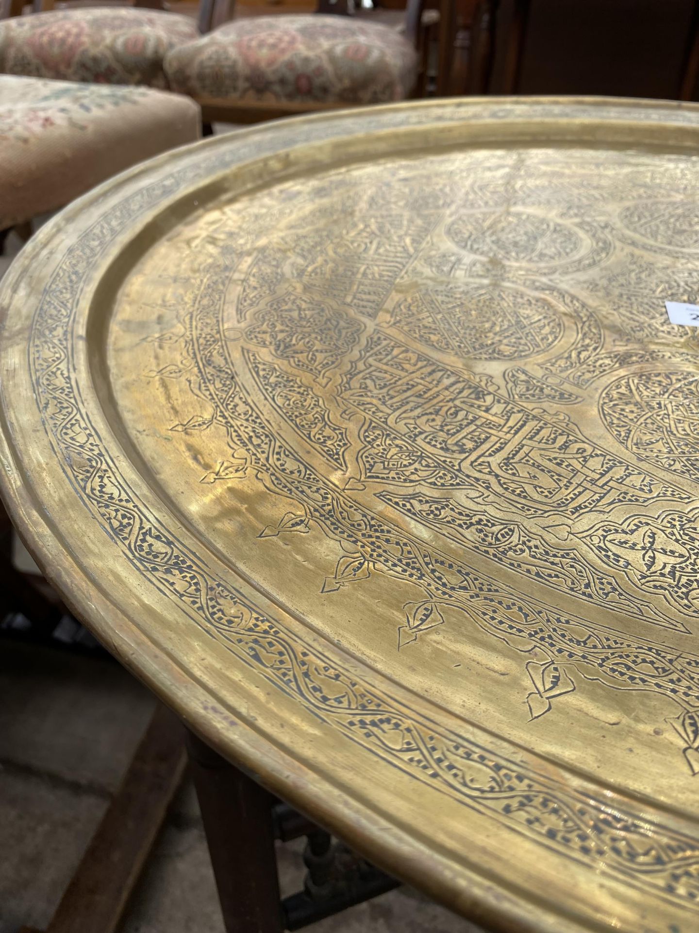 A MIDDLE EASTERN BRASS TABLE, 23.5" DIAMETER, ON FOLDING BASE - Image 3 of 3