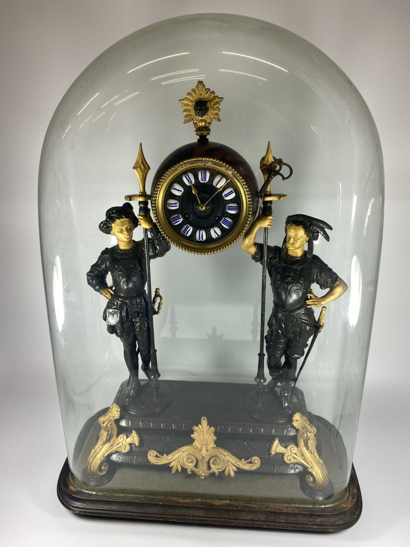 A FRENCH JAPY FERERES SPELTER TWO TRAIN DOMED CLOCK WITH TWIN FIGURAL DESIGN, DOME HEIGHT 64CM, WITH