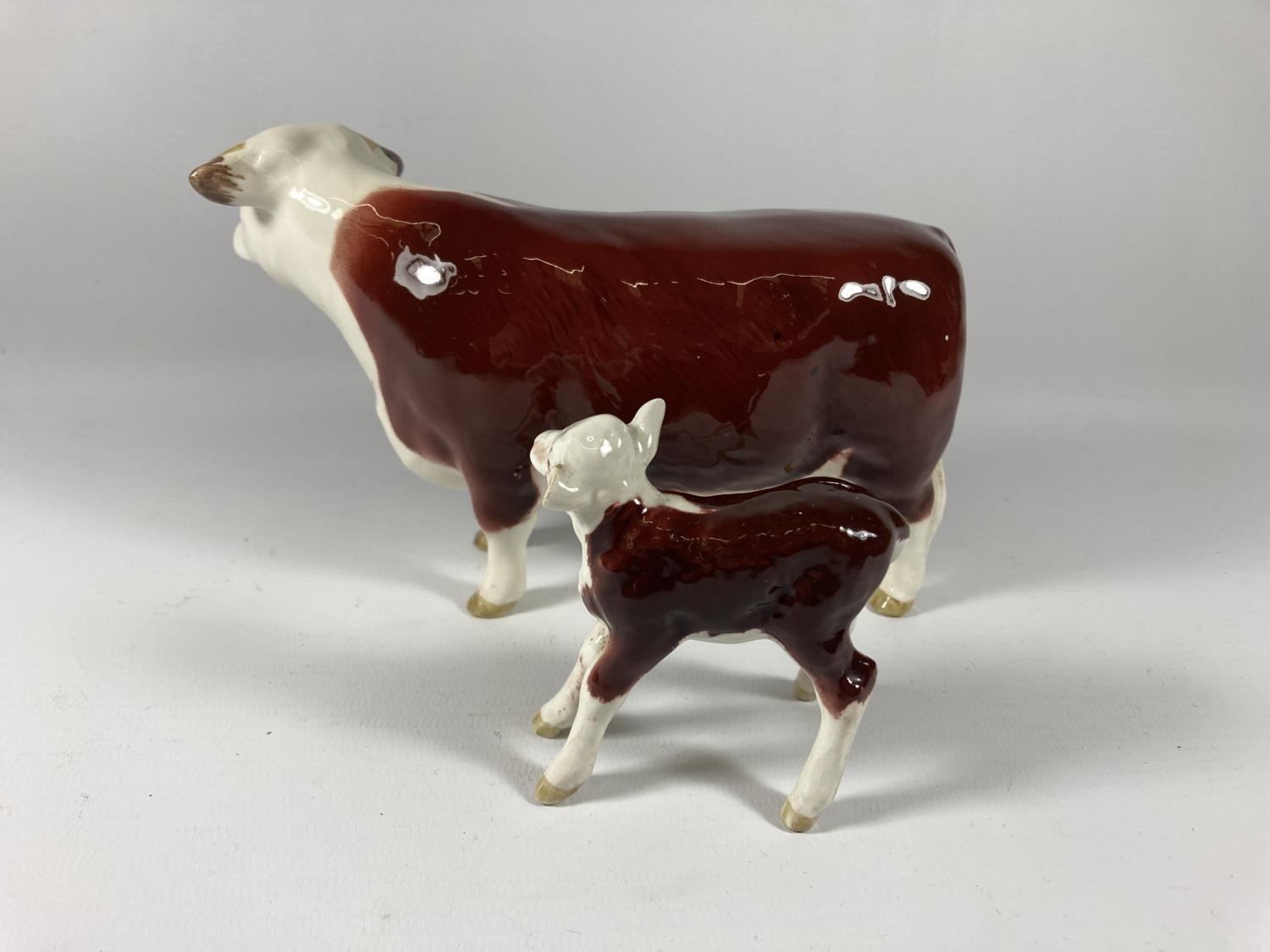 A BESWICK HEREFORD COW AND CALF (CALF EAR A/F) - Image 2 of 3