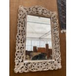 A DECORATIVE WHITE PAINTED WOODEN FRAMED WALL MIRROR